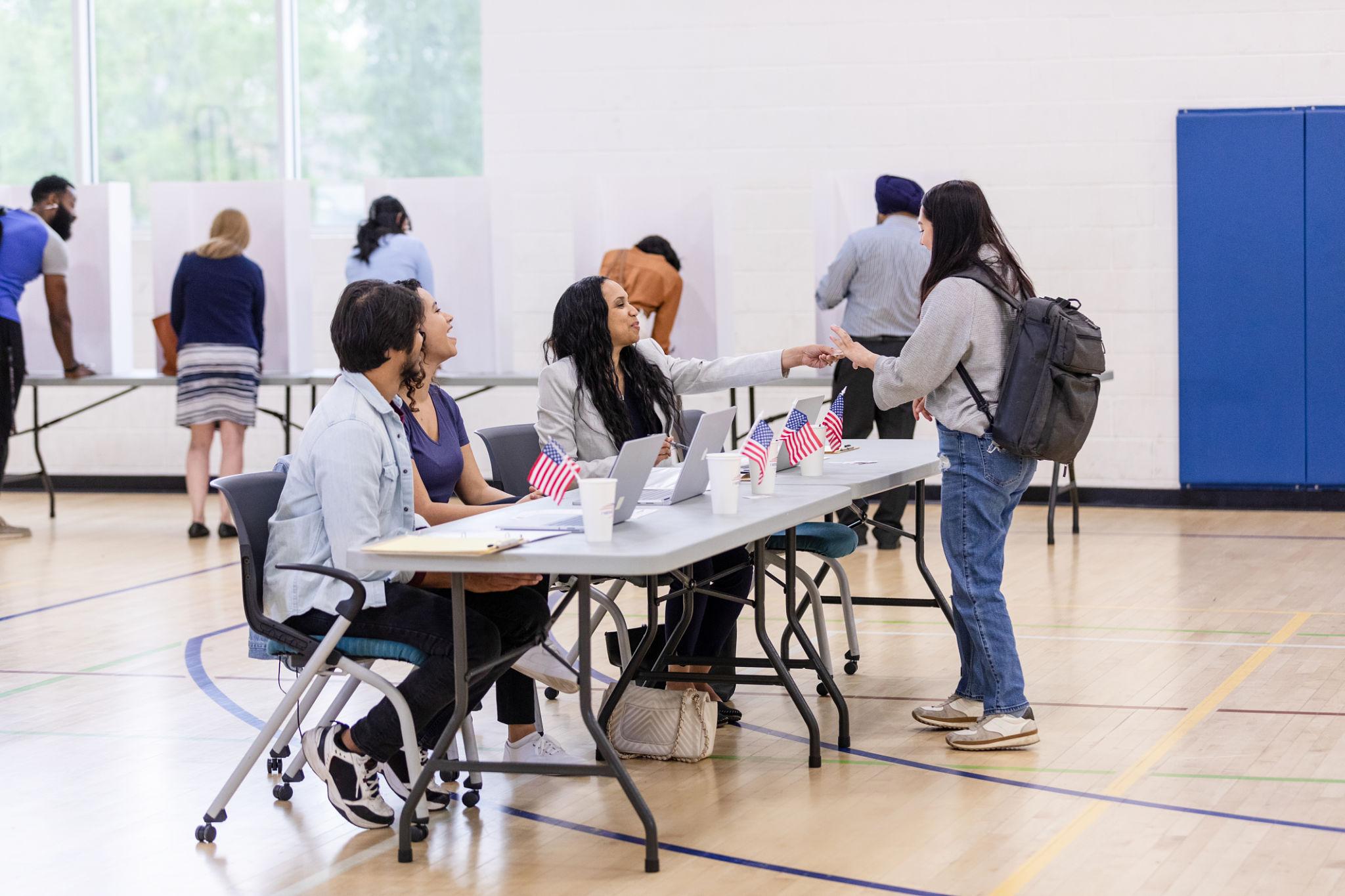 Poll workers checking in a voter during Election Day operations
